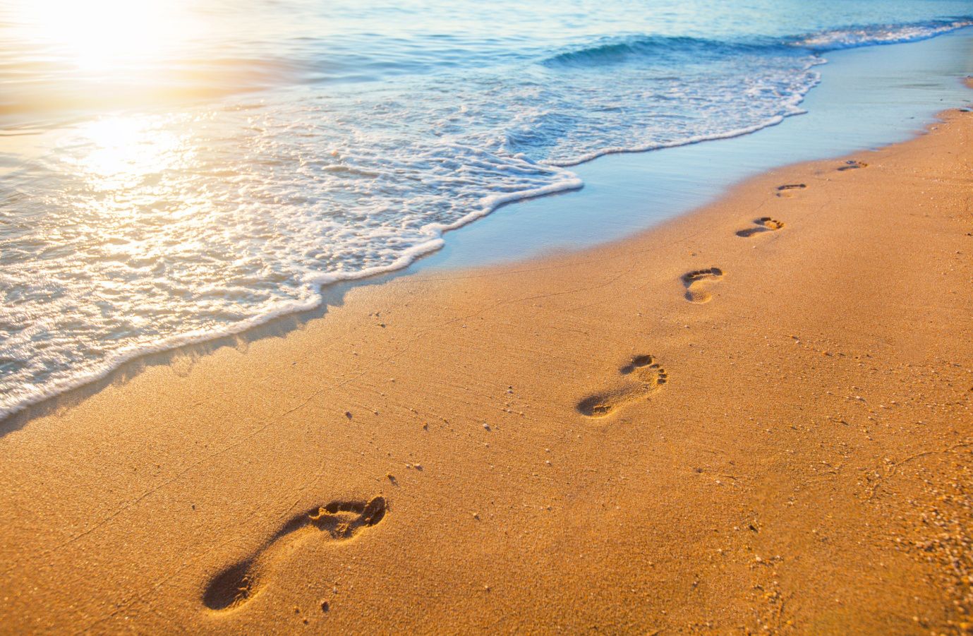 A picture of footprints on a beach. Cranstoun Footcare provides a professional and compassionate Podiatry and Chiropody service for the Lothians.