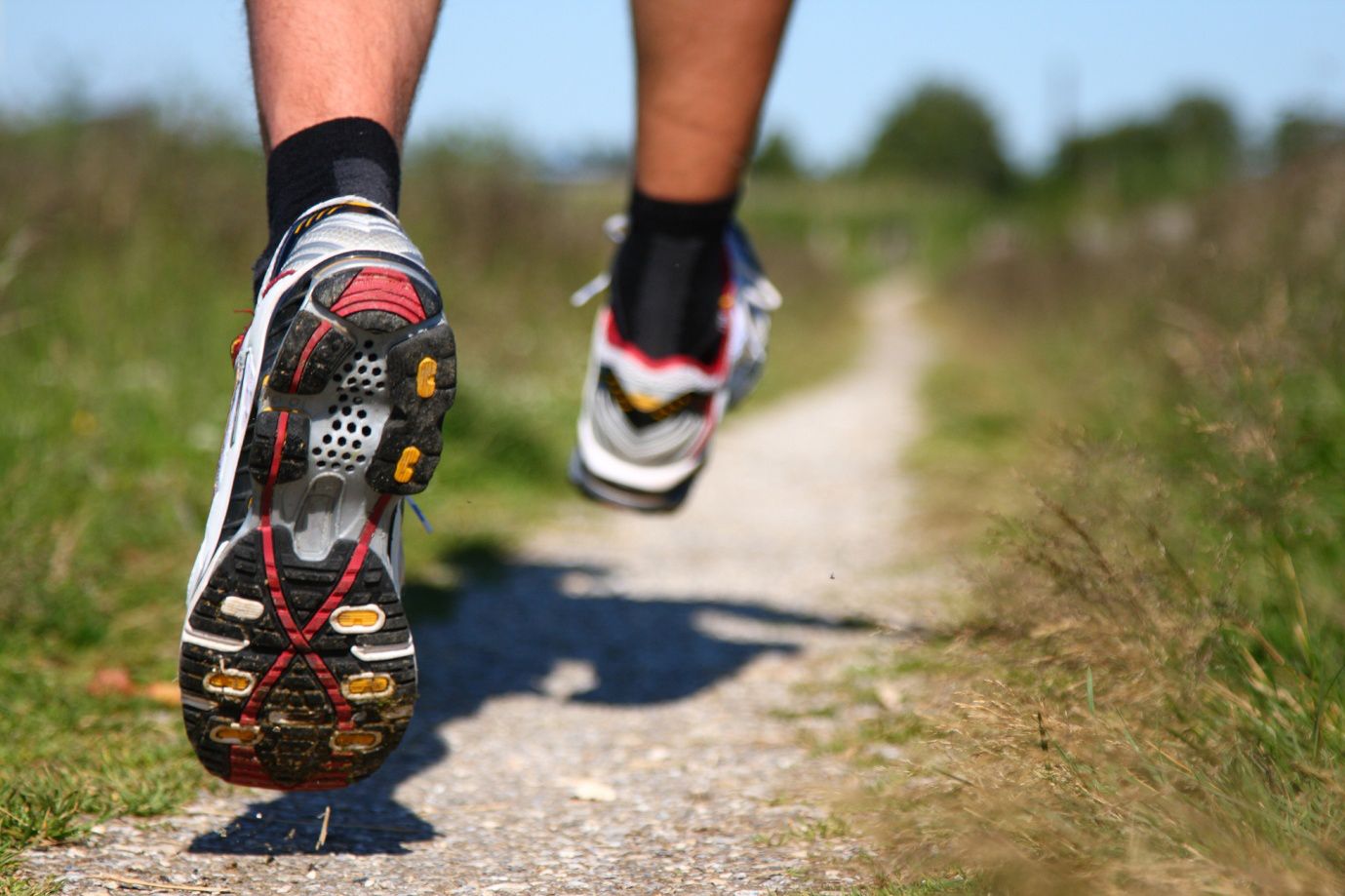 A picture of a runner's feet running down a country path. Foot health checks where health condition make the feet more vulnerable to problems. Cranstoun Footcare provides a professional and compassionate Podiatry and Chiropody service for the Lothians.